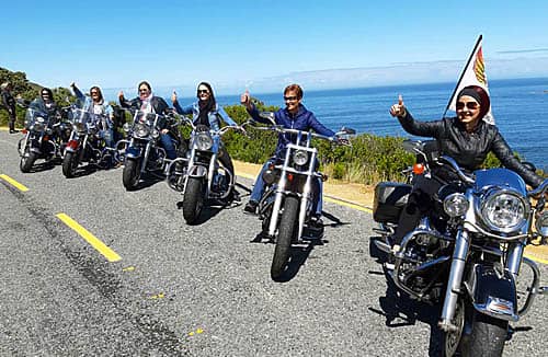 harley davidson tours ladies on harleys lined up on cape town coast