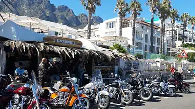 cape corportate tours harley davidson chauffeur rides harleys in front of beach house camps bay
